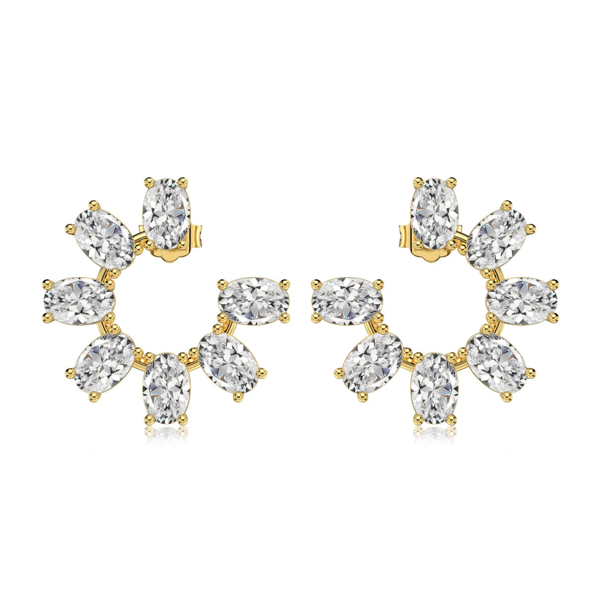 Gold and clear gemstone earrings on a white background