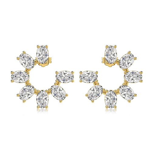 Gold and clear gemstone earrings on a white background