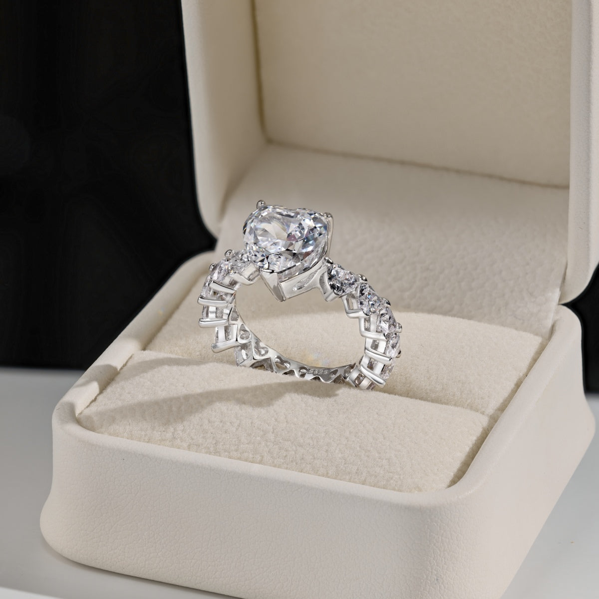 heart Diamond ring set in a jewelry box on a neutral background