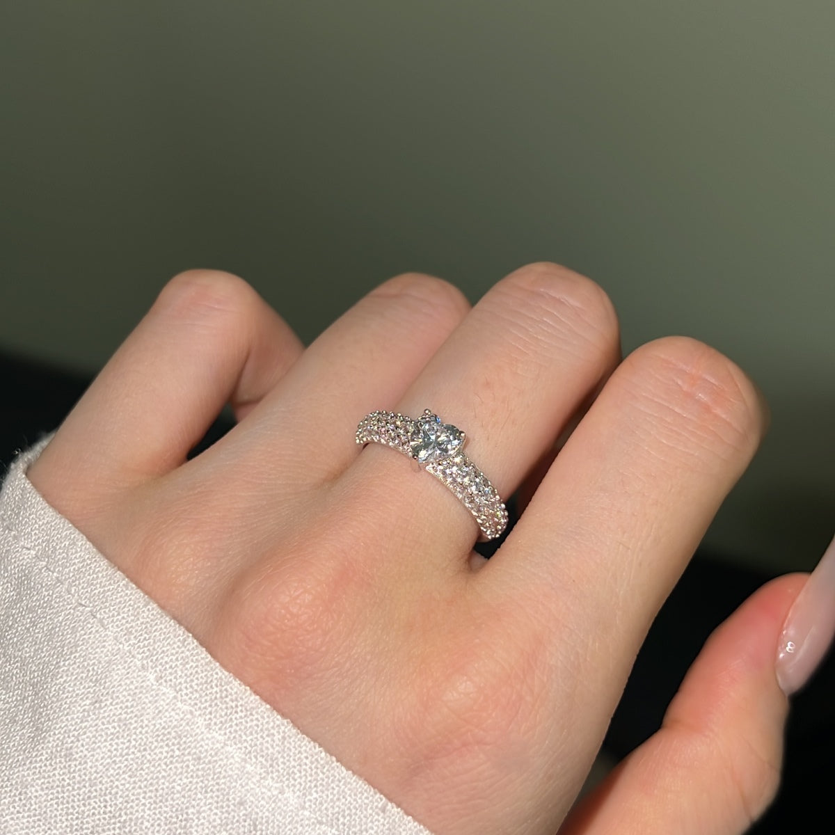 woman showing silver heart ring with pave zircon chunky band