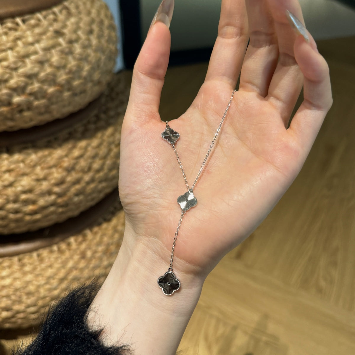 hand showing four leaf clover pendant necklace