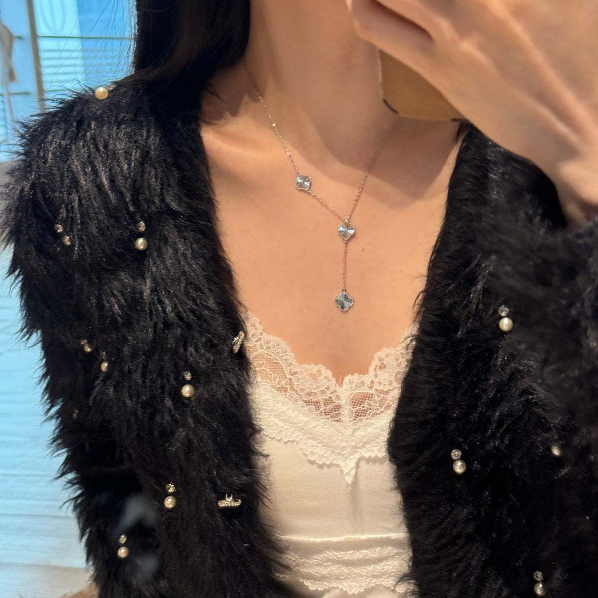 woman wearing a four leaf clover drop necklace