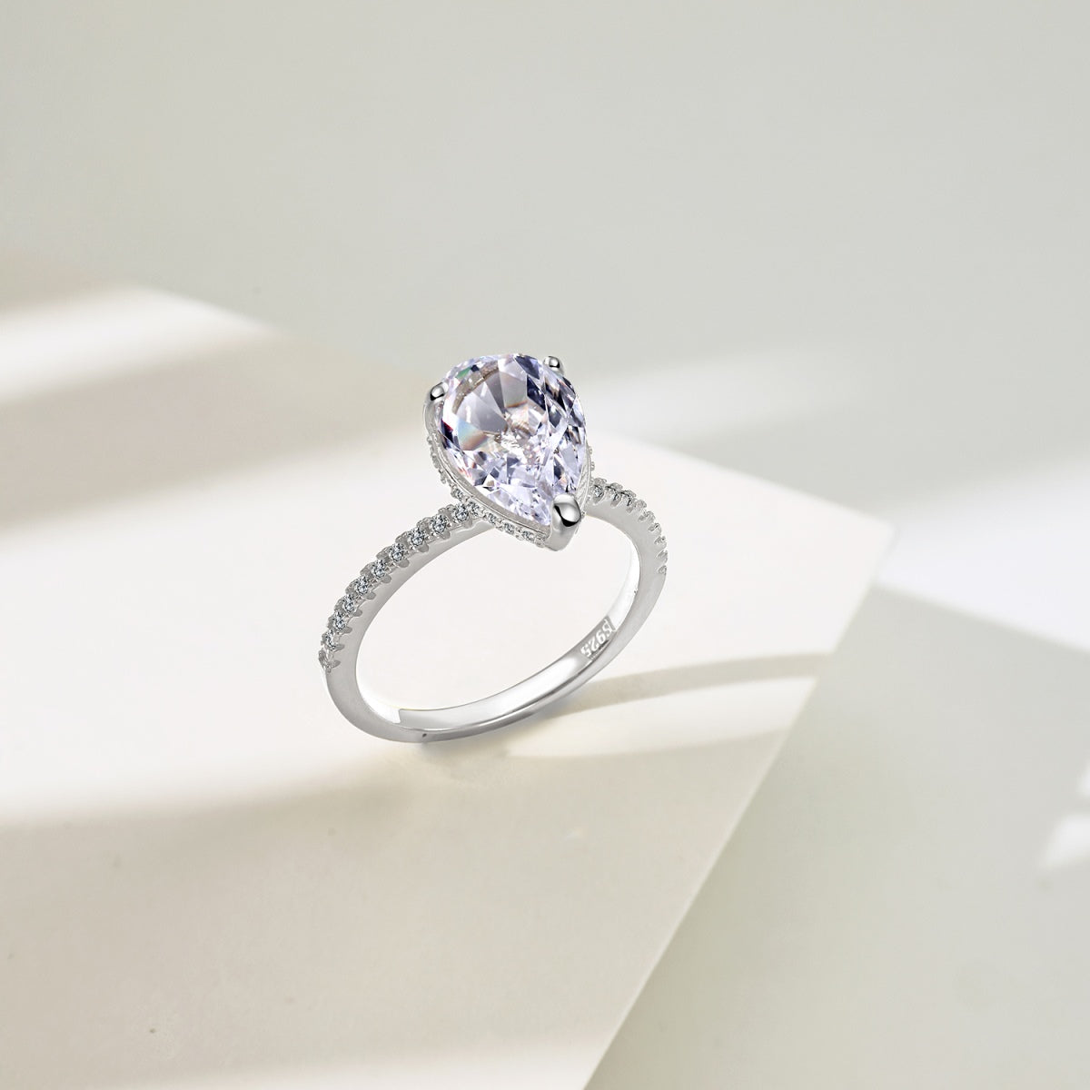 teardrop diamond ring standing on white background