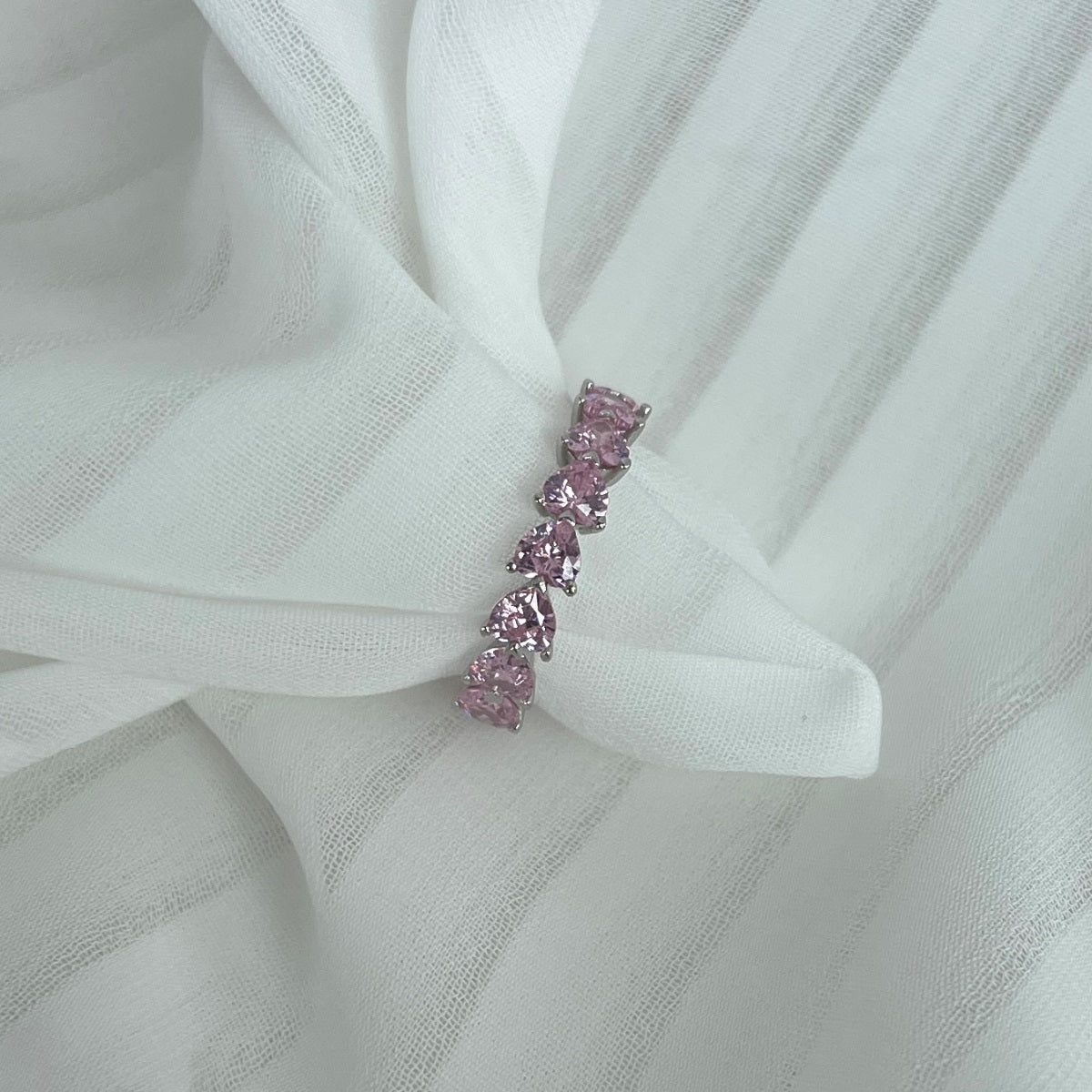 Pink gemstone ring on a white fabric background
