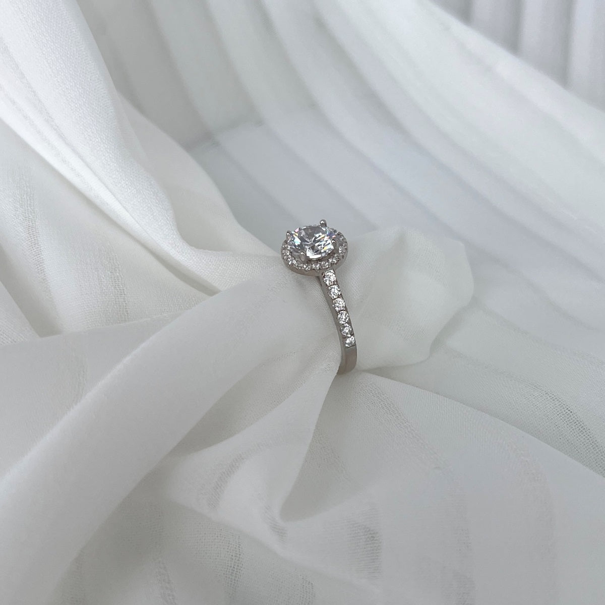Diamond ring on a white fabric background