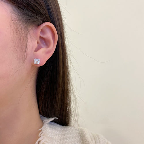 woman wearing diamond stud earrings