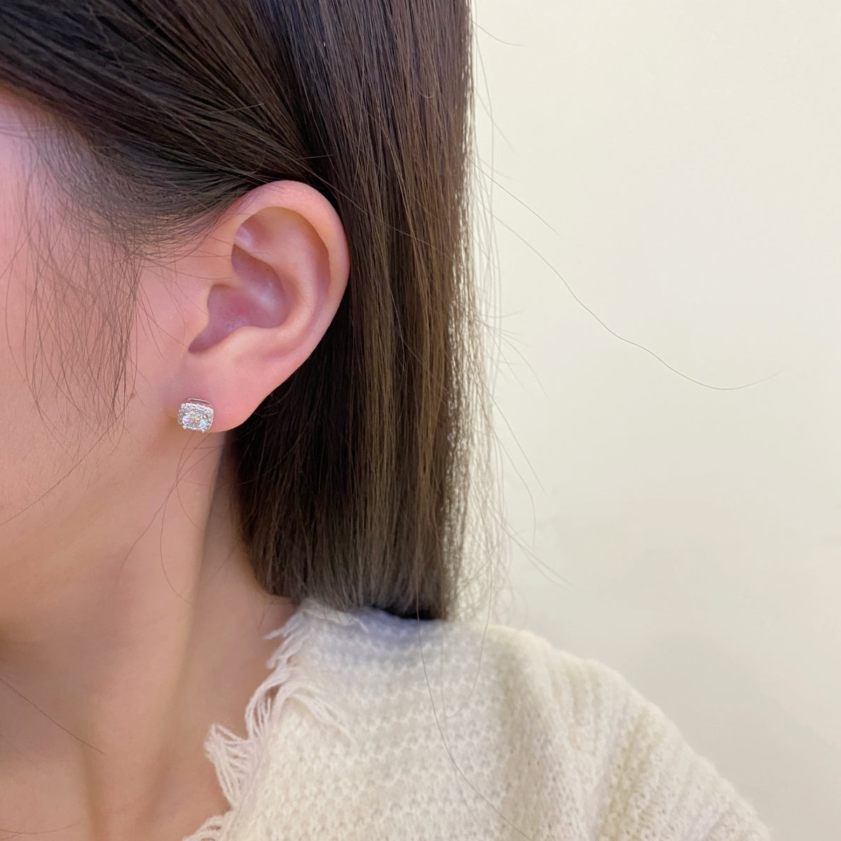 woman wearing diamond studs in a photoshoot