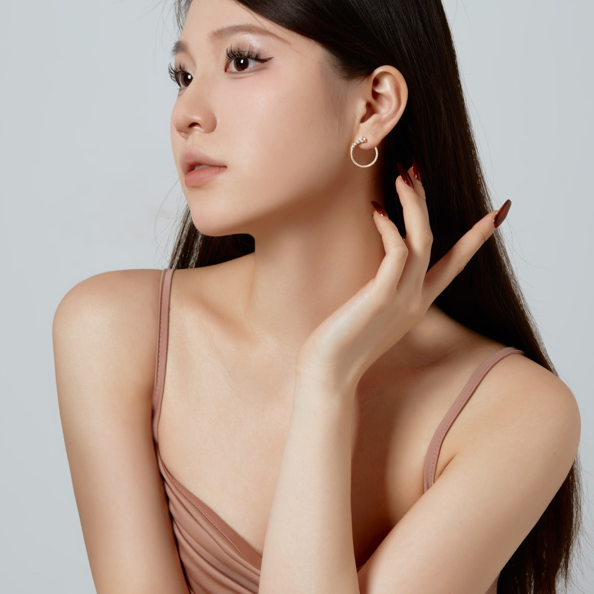 Woman wearing a beige dress with a plain background
